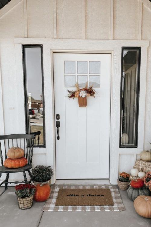 minimalist fall front porch with dried flowers hanging from front door