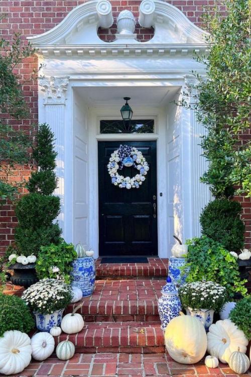 elegant fall front porch with ginger jars