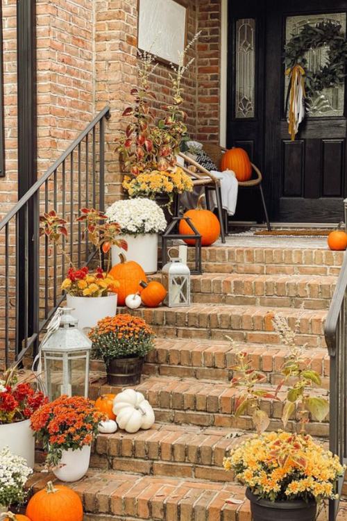 fall front porch with brick steps and pumpkins and lanterns