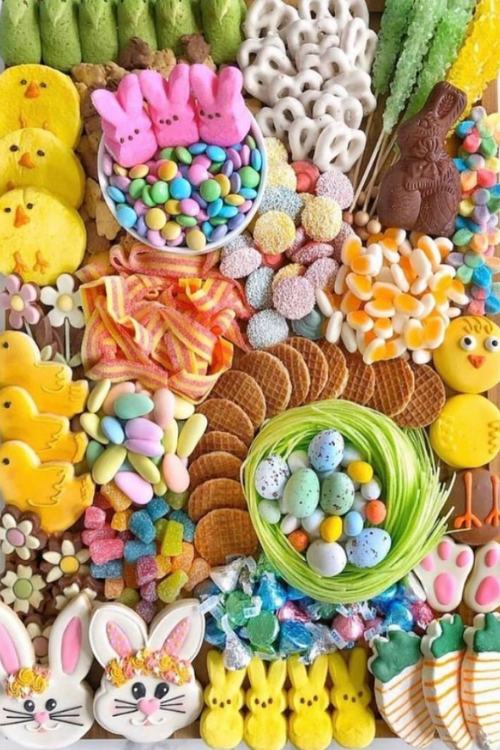 easter candy themed charcuterie board with bright colored candy