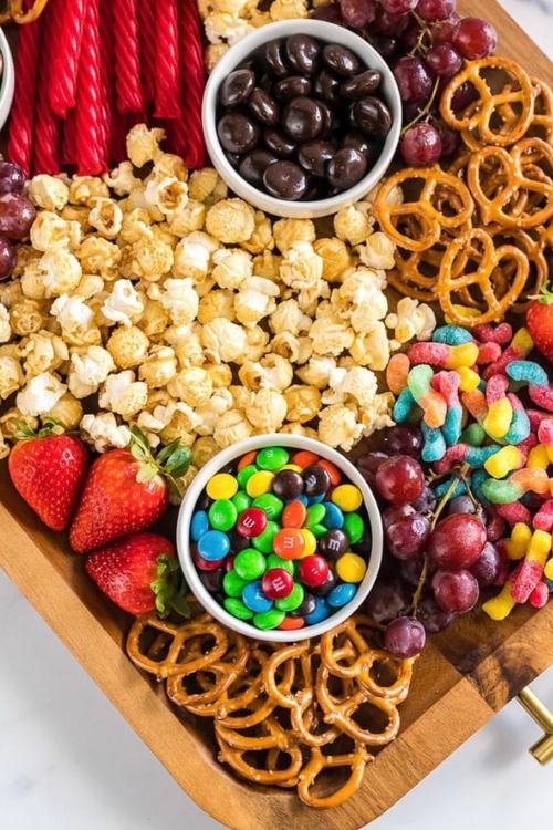 movie night charcuterie board with popcorn, candy, pretzels and fruit