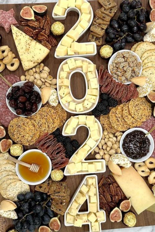 new years charcuterie board with "2024" numbers filled with cheeses