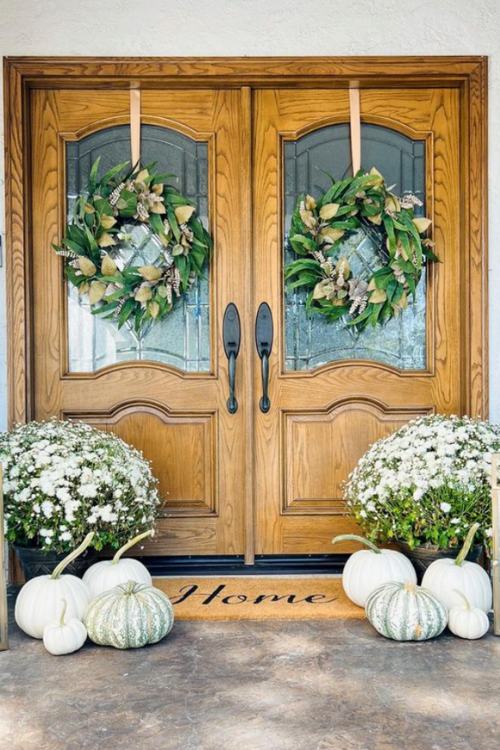 fall front porch with white pumpkins and white potted flowers