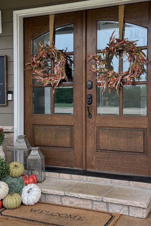 fall front porch with two wreaths on french doors