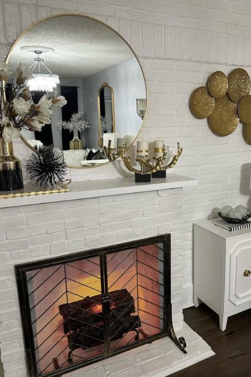 white fireplace with gold mantel decor