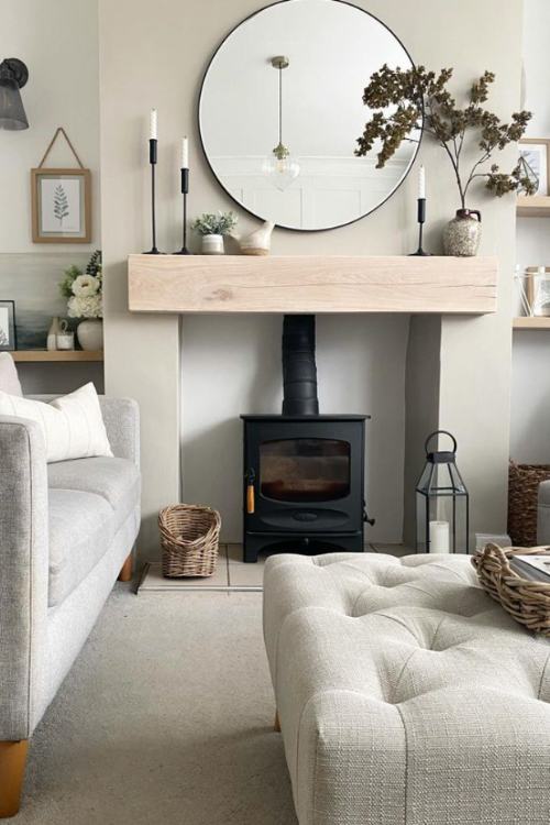 round mirror hanging over wood fireplace mantel