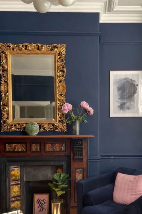 ornate gold mirror hanging over fireplace mantel