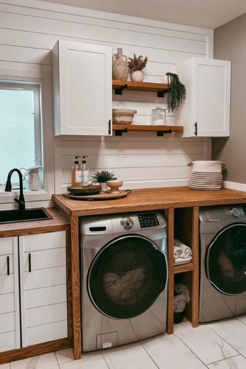 laundry room with wood countertop and white cabinets