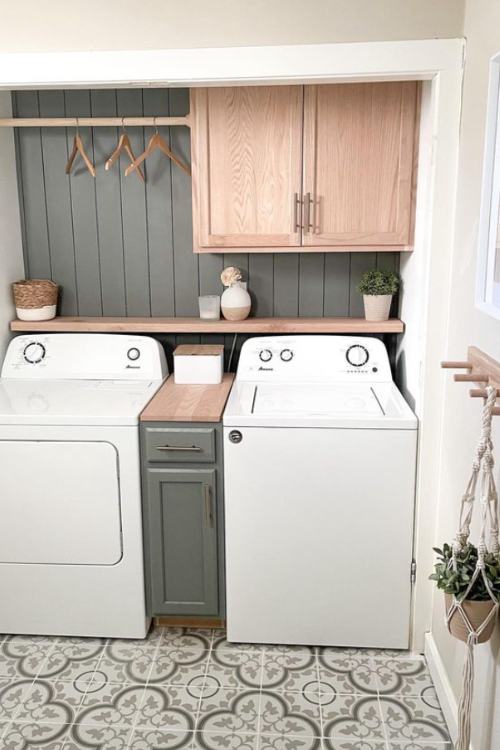 laundry room with hangers hanging on bar above washing machines