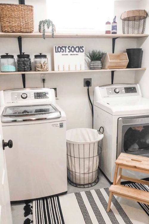 laundry room with lost socks sign next to pegs