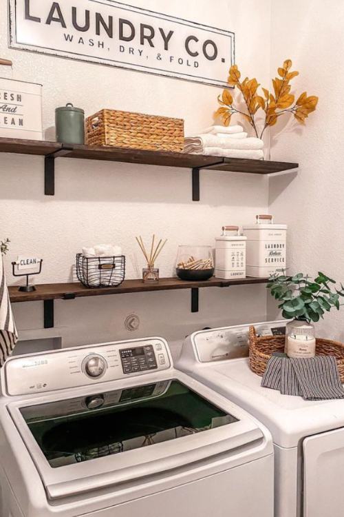 laundry room with two vases of dried branches