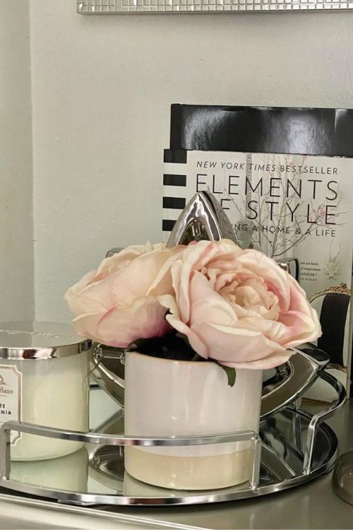 nightstand decor with mirrored silver tray with small vase of roses