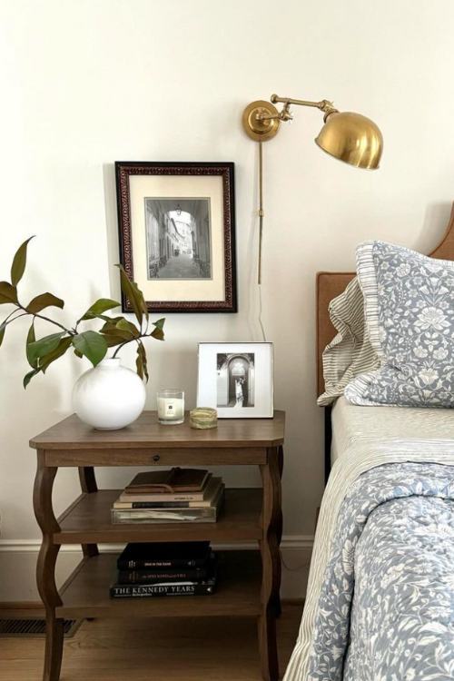 antique nightstand with white vase with leafy branches