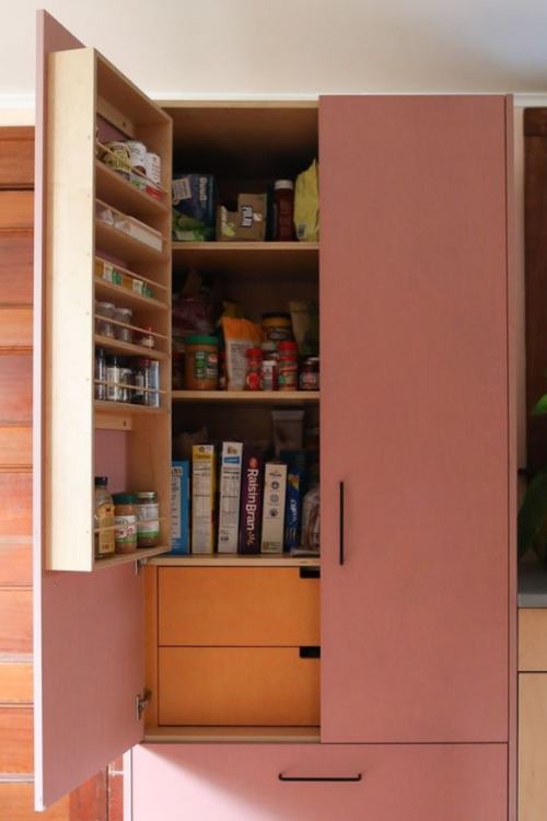 pantry with wooden spice rack filled with spices inside 