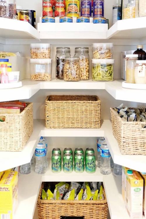 well organized pantry with baskets and clear containers 